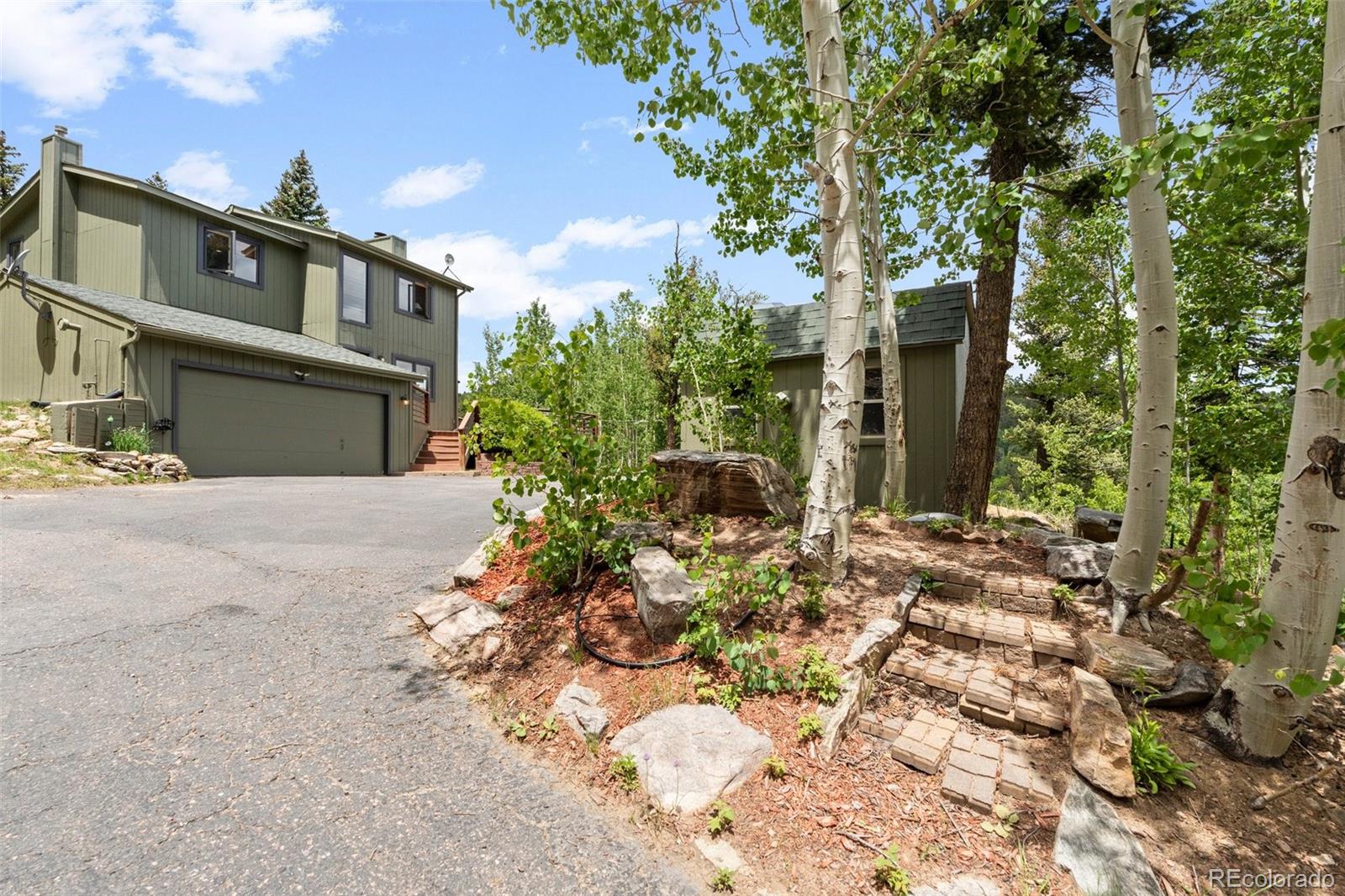 1682 Sinton Road Evergreen, CO 80439 - Photo 34 of 40 a view of a house with a tree in the background