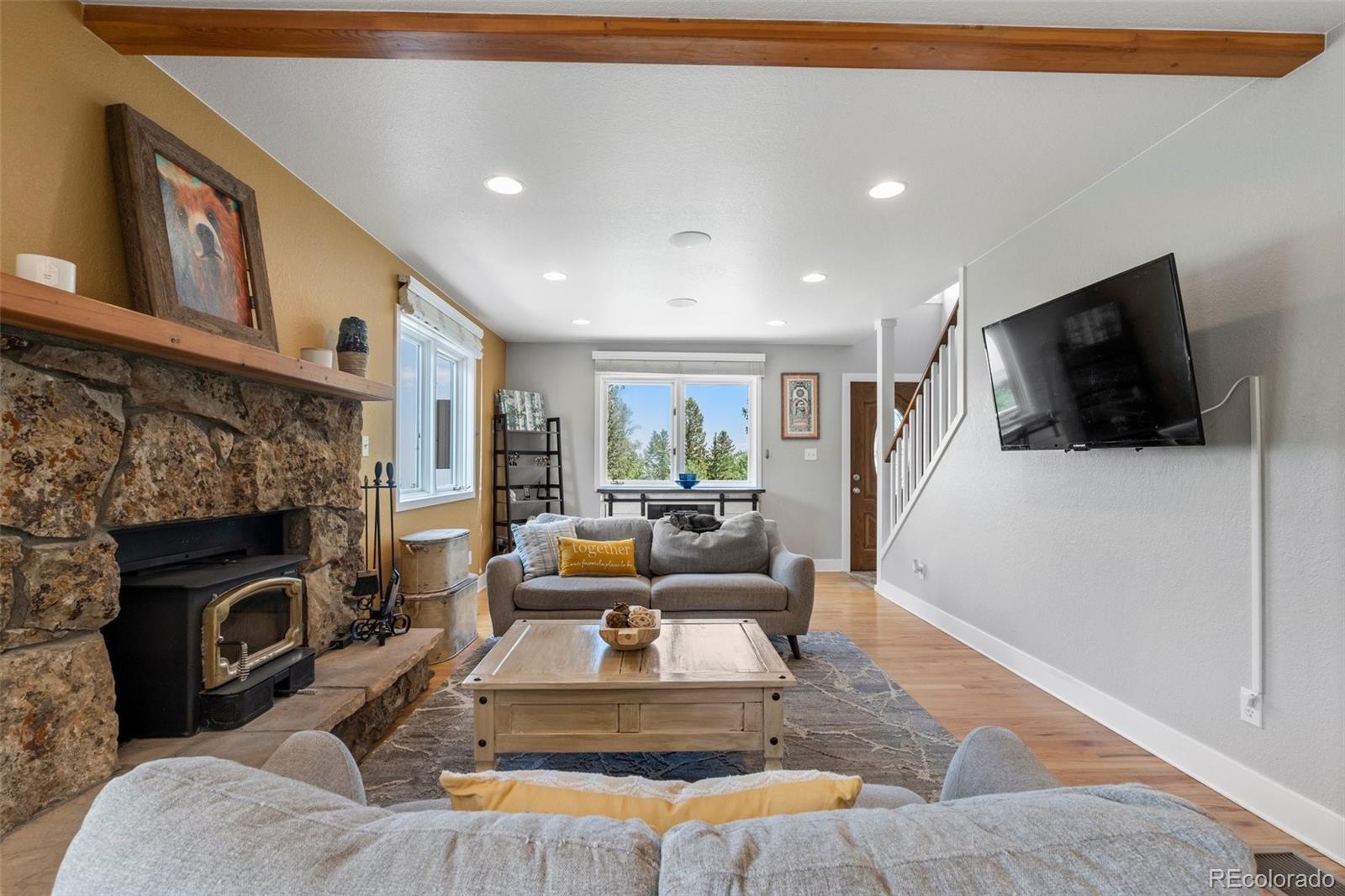 1682 Sinton Road Evergreen, CO 80439 - Photo 4 of 40 a living room with furniture and a fireplace
