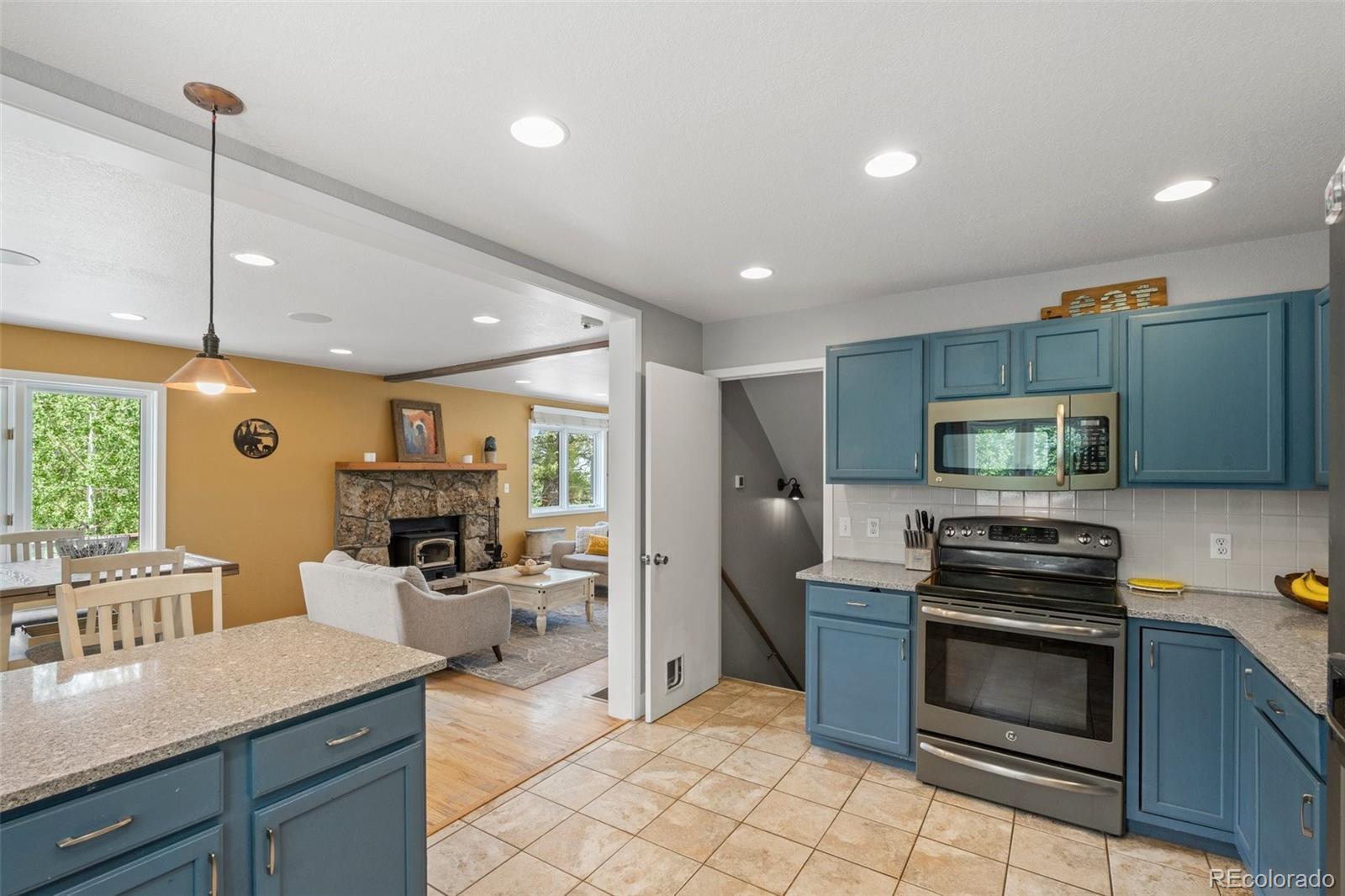 1682 Sinton Road Evergreen, CO 80439 - Photo 9 of 40 a kitchen with a sink a stove and stainless steel appliances