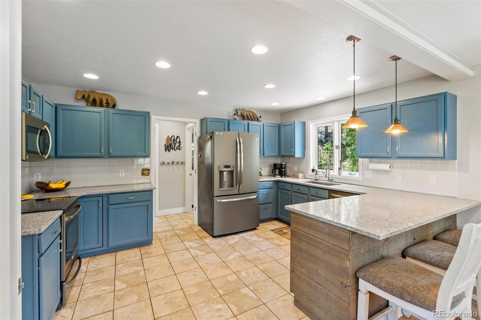 1682 Sinton Road Evergreen, CO 80439 - Photo 10 of 40 a kitchen with a refrigerator a sink and dishwasher