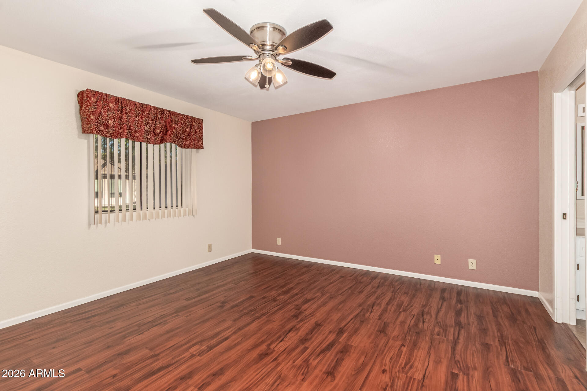 520 South Greenfield Road, Unit 30 Mesa, AZ 85206 - Photo 13 of 29 an empty room with wooden floor and windows