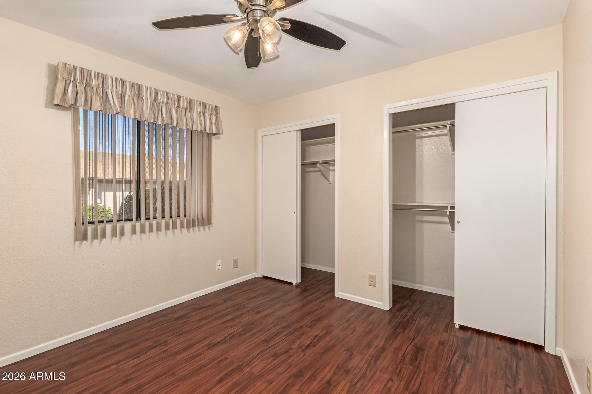 520 South Greenfield Road, Unit 30 Mesa, AZ 85206 - Photo 19 of 29 a view of an empty room with a window and wooden floor