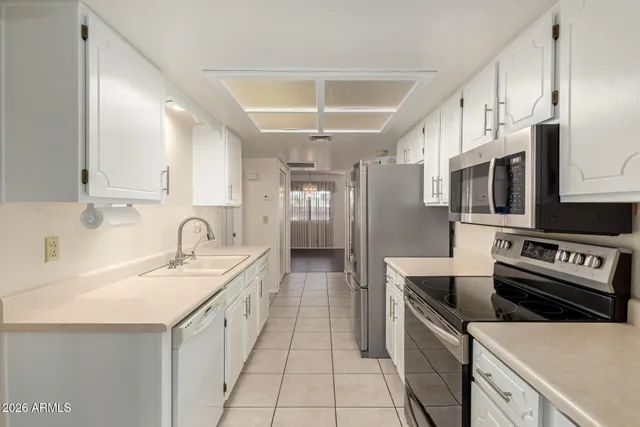 a kitchen with stainless steel appliances granite countertop a sink and a stove