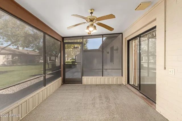 a view of washer and dryer with bathroom in the background