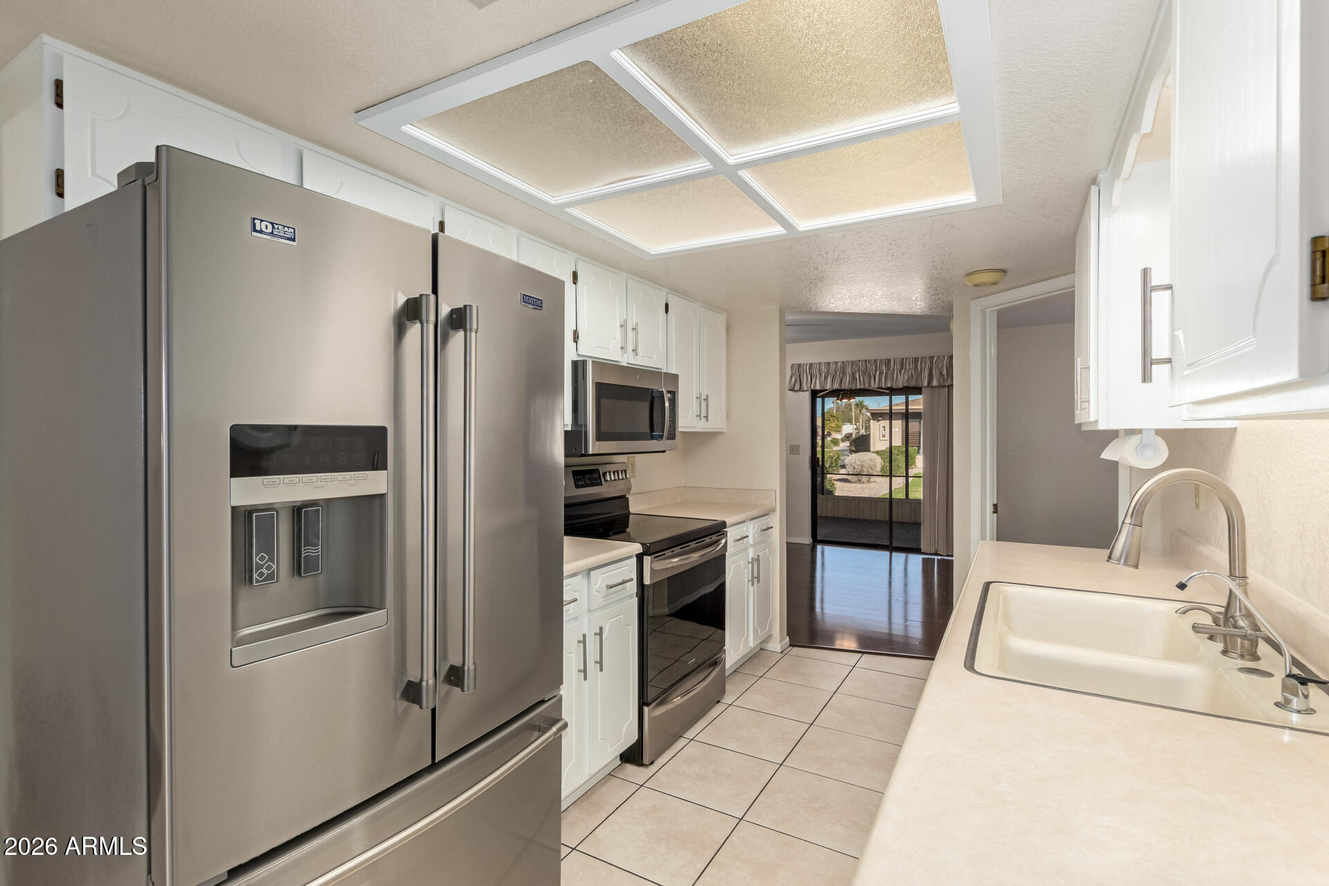 520 South Greenfield Road, Unit 30 Mesa, AZ 85206 - Photo 9 of 29 a kitchen with stainless steel appliances a refrigerator sink and cabinets