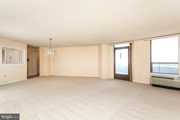 an empty room with windows and closet