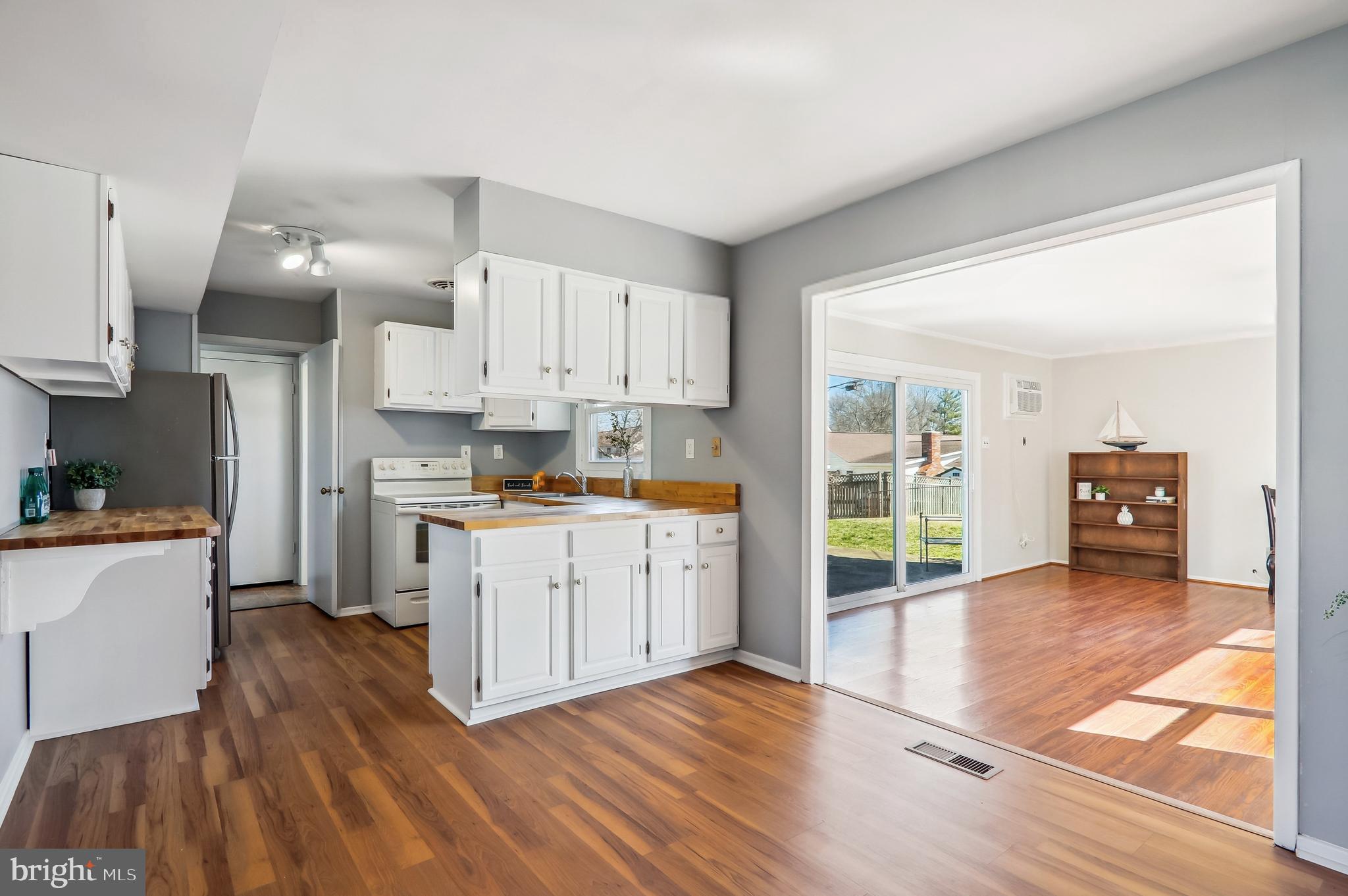 12403 Shawmont Lane Bowie, MD 20715 - Photo 13 of 59 a kitchen with granite countertop a stove a sink and a refrigerator