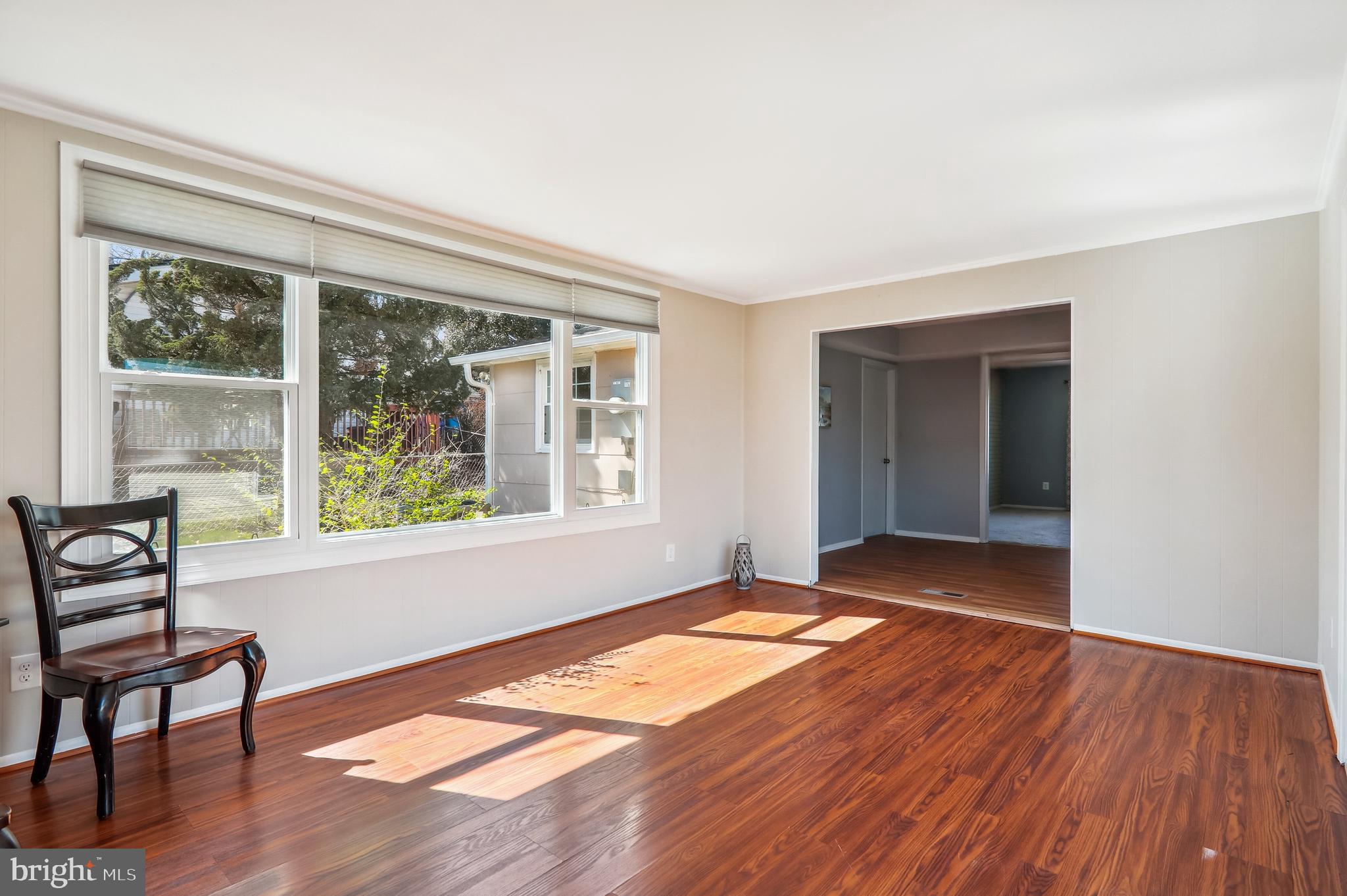 12403 Shawmont Lane Bowie, MD 20715 - Photo 15 of 59 a view of an empty room with wooden floor and a window