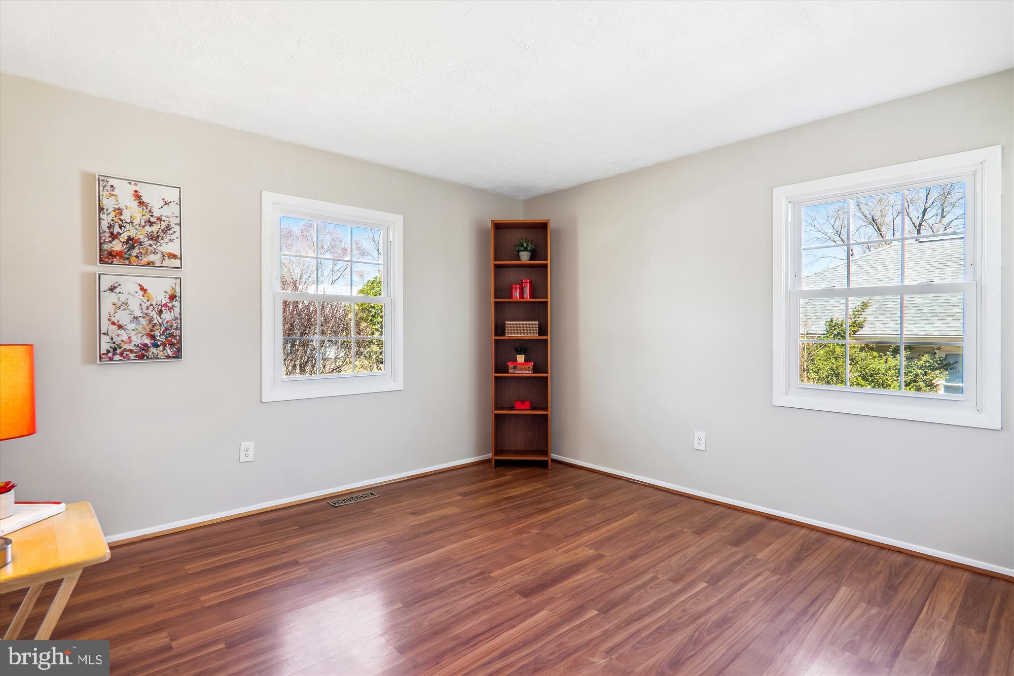 12403 Shawmont Lane Bowie, MD 20715 - Photo 20 of 59 a view of an empty room with wooden floor and a window