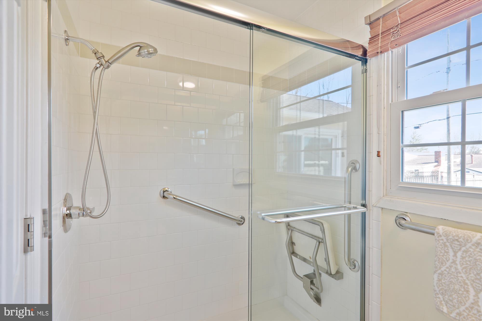 12403 Shawmont Lane Bowie, MD 20715 - Photo 27 of 59 a bathroom with a glass shower door