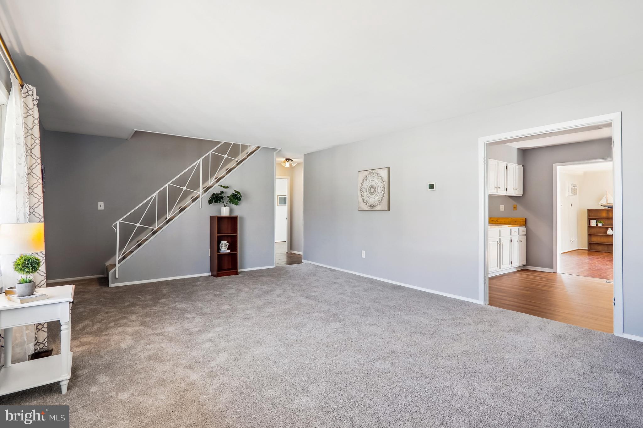 12403 Shawmont Lane Bowie, MD 20715 - Photo 29 of 59 a view of a livingroom with wooden floor and stairs