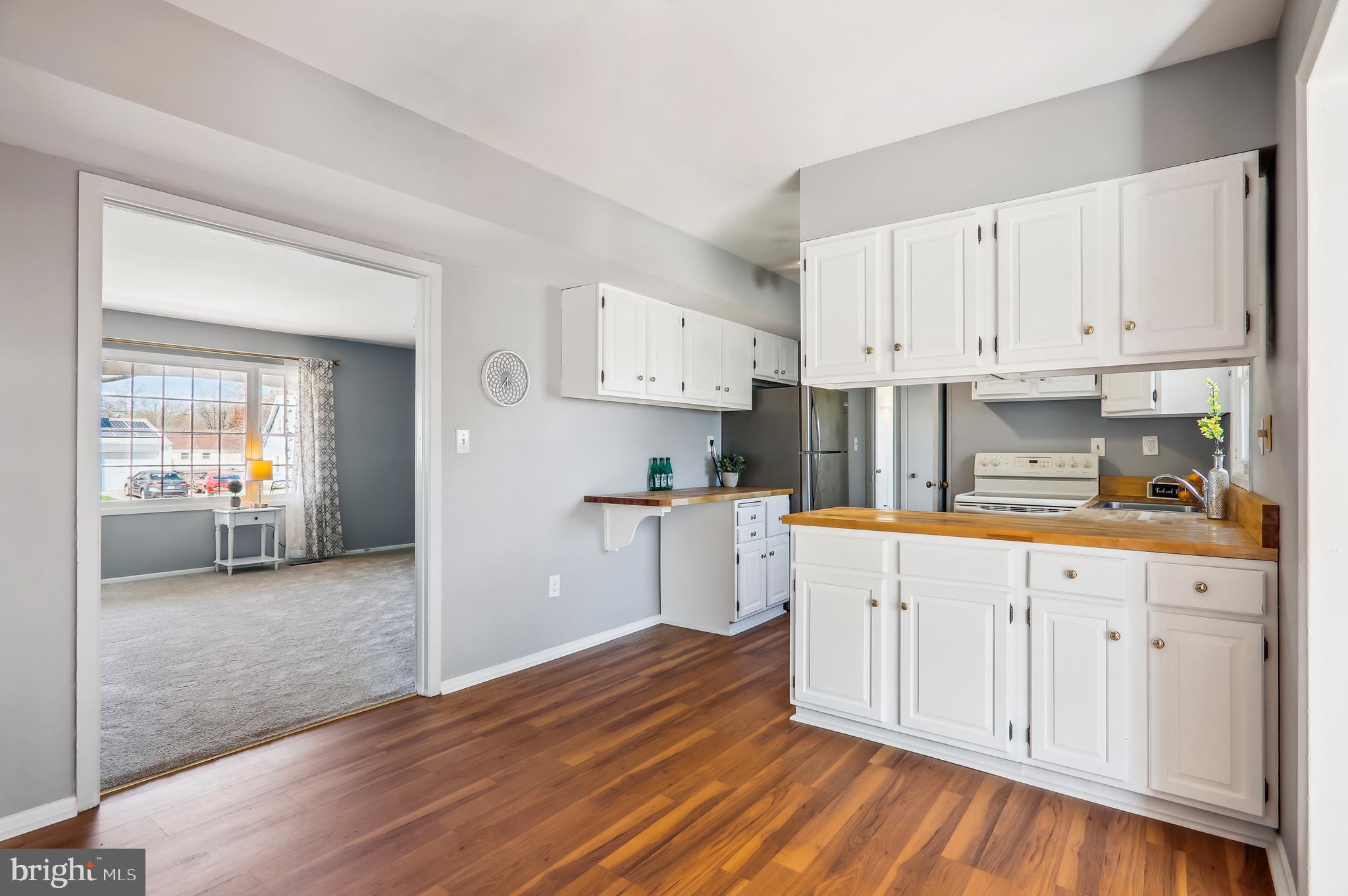 12403 Shawmont Lane Bowie, MD 20715 - Photo 8 of 59 a kitchen with granite countertop white cabinets and white appliances