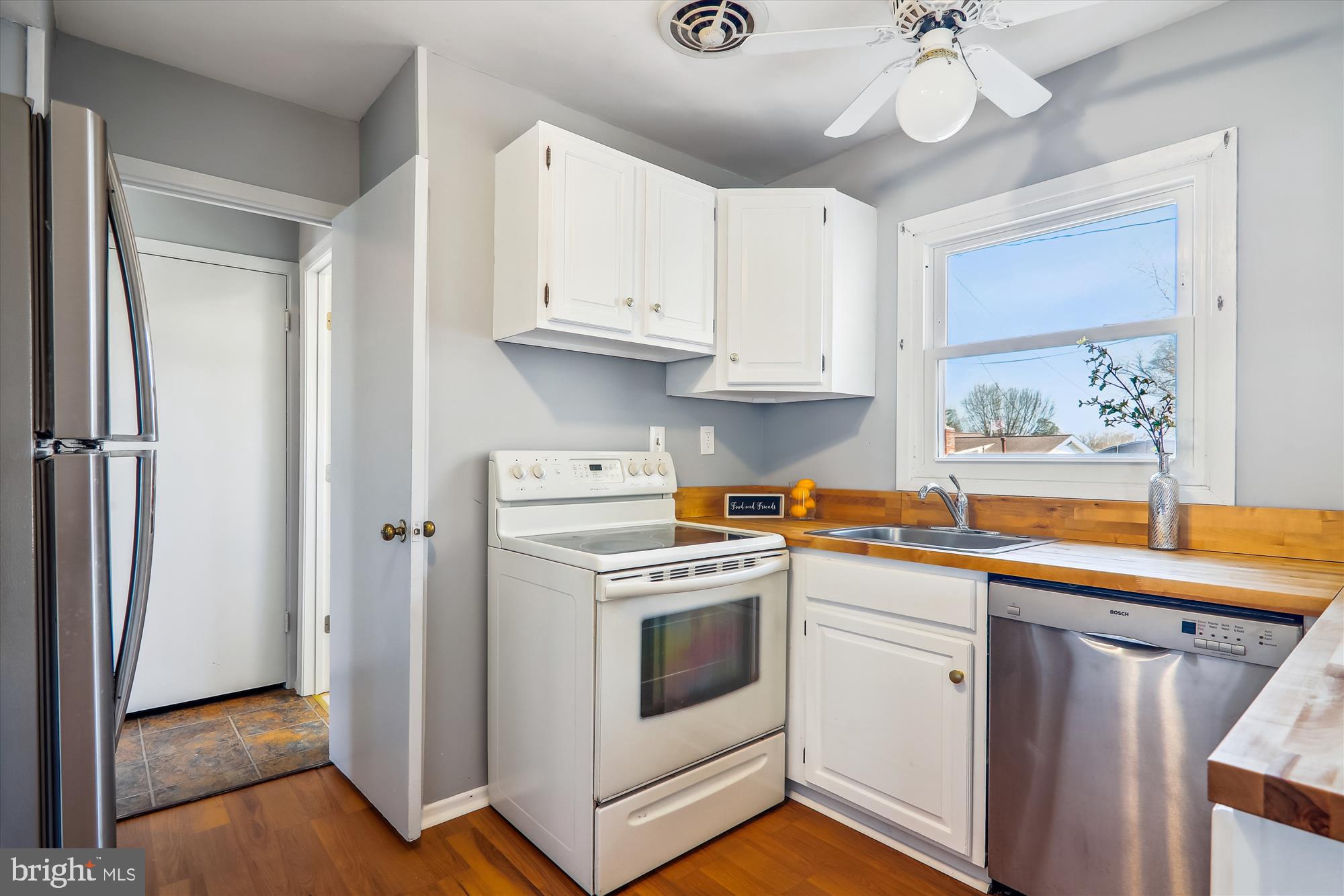 12403 Shawmont Lane Bowie, MD 20715 - Photo 10 of 59 a kitchen with stainless steel appliances granite countertop a stove a sink and a refrigerator with white cabinets