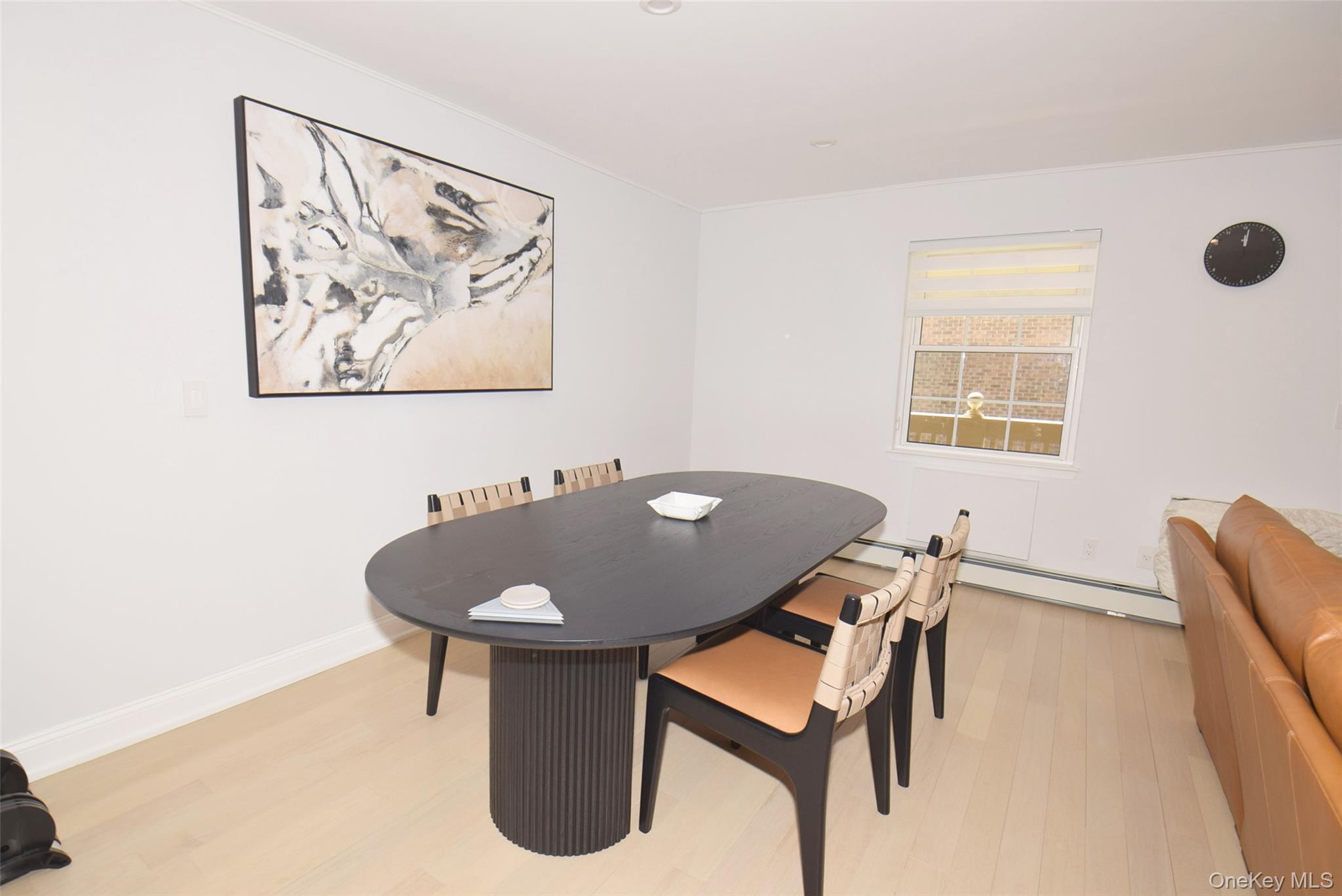 208-08 Robert Road, Unit 191M Queens, NY 11360 - Photo 11 of 37 a dining room with furniture and window