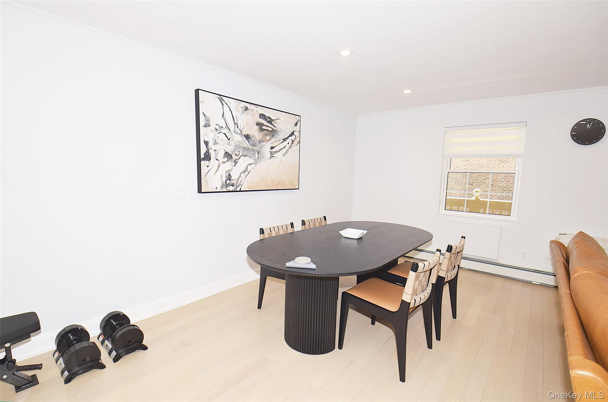 208-08 Robert Road, Unit 191M Queens, NY 11360 - Photo 15 of 37 a table and chairs in a room with a table and chairs
