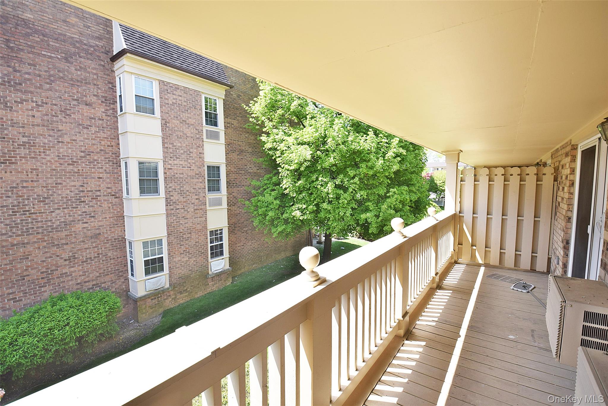 208-08 Robert Road, Unit 191M Queens, NY 11360 - Photo 17 of 37 a view of a balcony with wooden floor