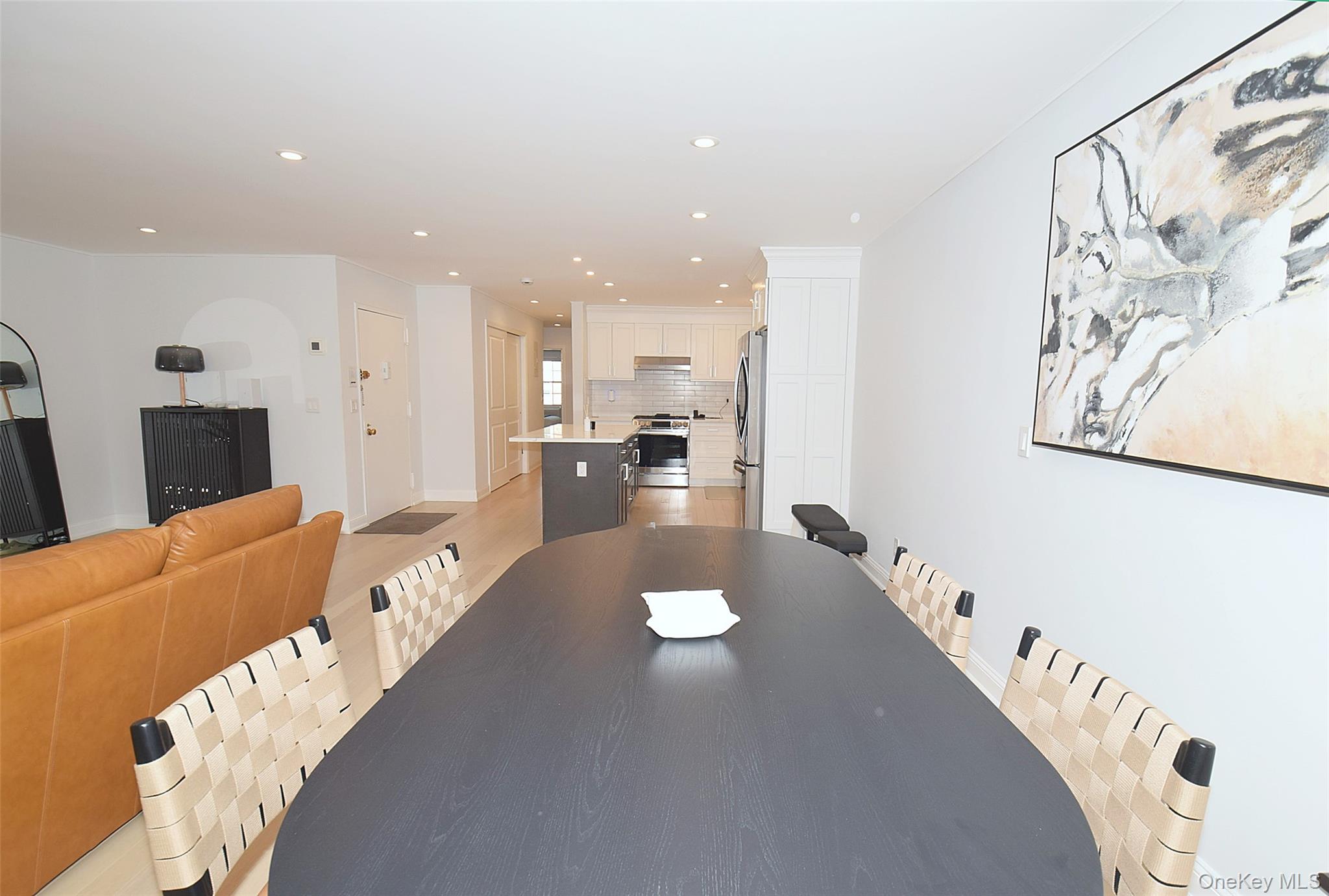 208-08 Robert Road, Unit 191M Queens, NY 11360 - Photo 19 of 37 a living room with furniture and a large window