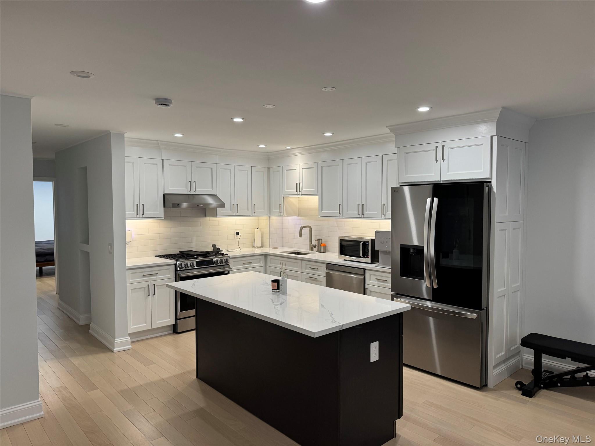 208-08 Robert Road, Unit 191M Queens, NY 11360 - Photo 2 of 37 a kitchen with stainless steel appliances granite countertop a refrigerator and a stove top oven