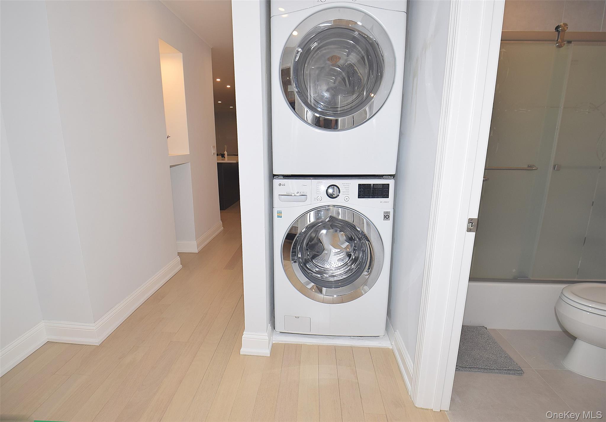 208-08 Robert Road, Unit 191M Queens, NY 11360 - Photo 21 of 37 a utility room with dryer and washer