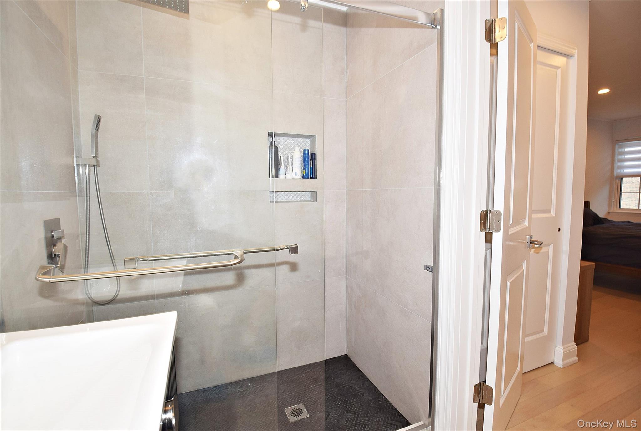208-08 Robert Road, Unit 191M Queens, NY 11360 - Photo 25 of 37 a bathroom with a shower and a sink