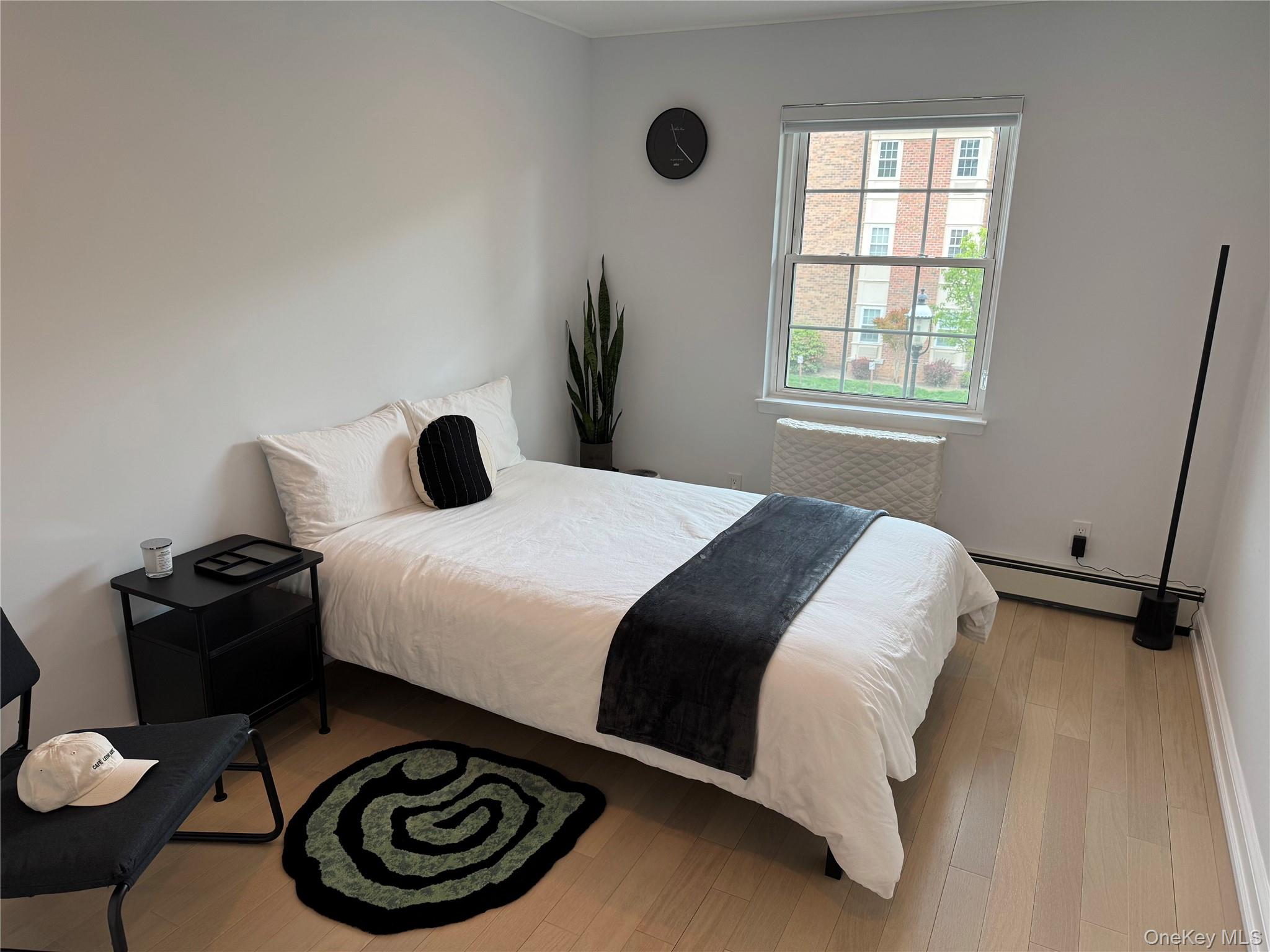 208-08 Robert Road, Unit 191M Queens, NY 11360 - Photo 6 of 37 a bedroom with a bed and a window