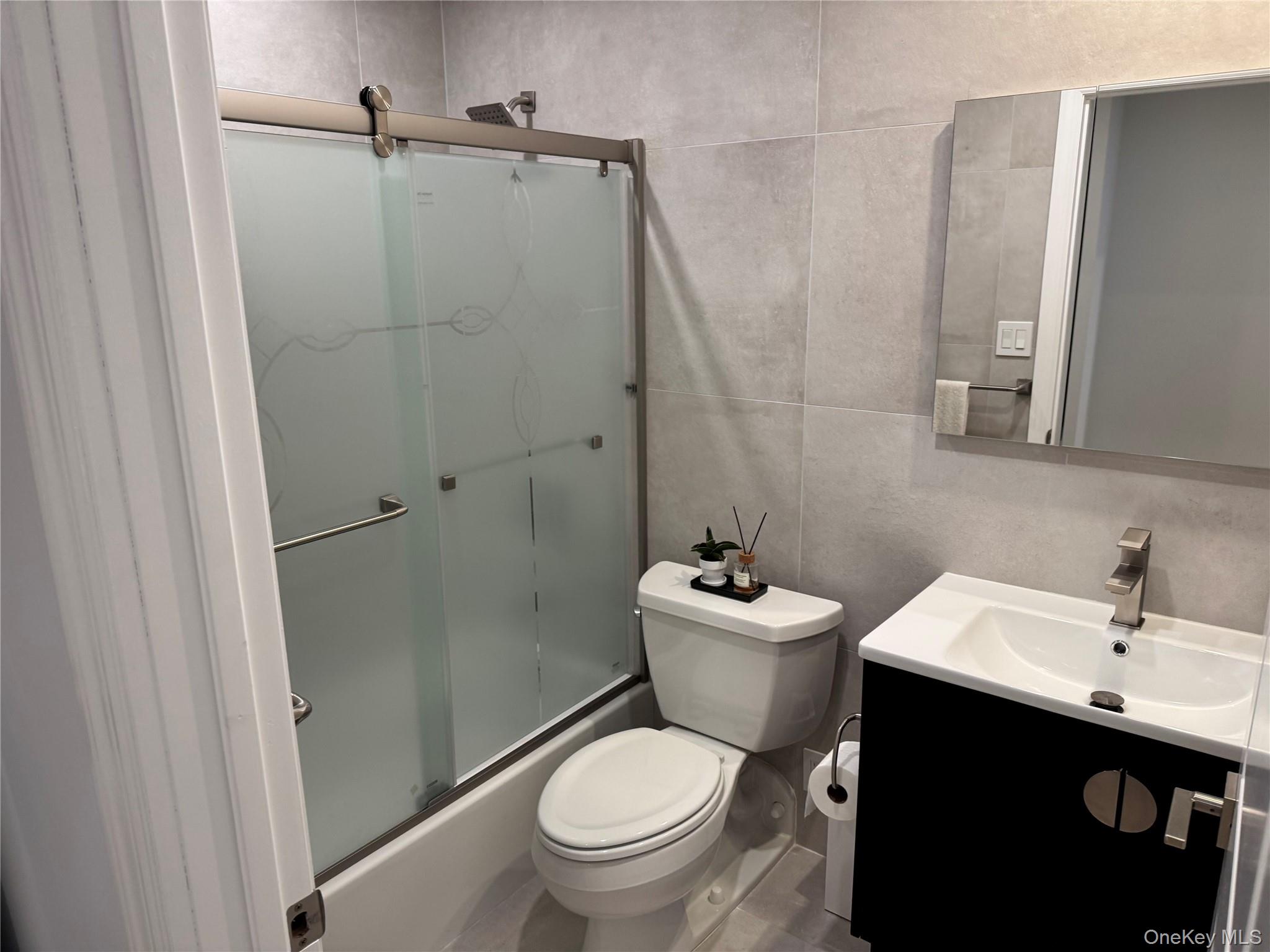 208-08 Robert Road, Unit 191M Queens, NY 11360 - Photo 8 of 37 a bathroom with a toilet sink shower and mirror