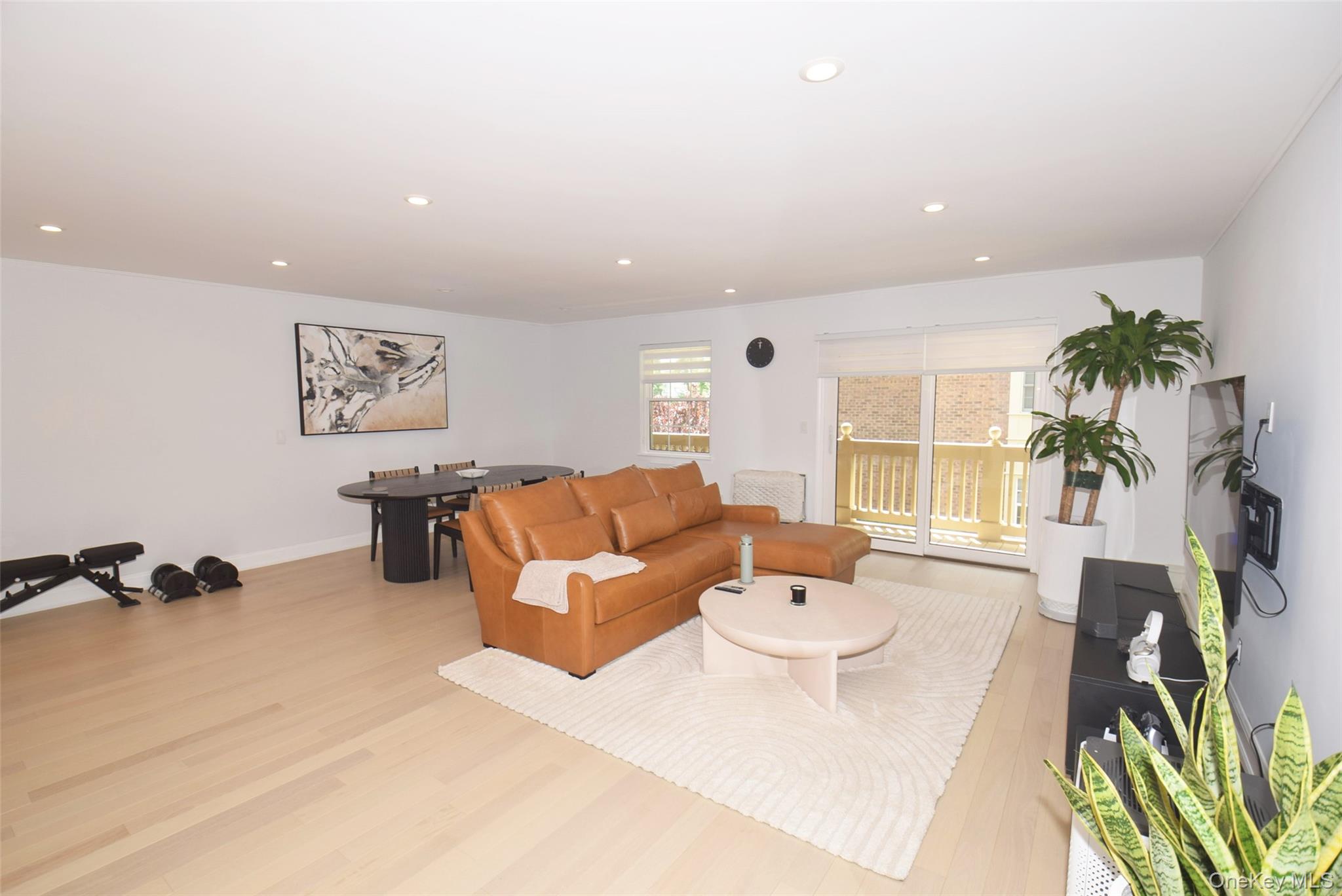 208-08 Robert Road, Unit 191M Queens, NY 11360 - Photo 10 of 37 a living room with furniture and a large window