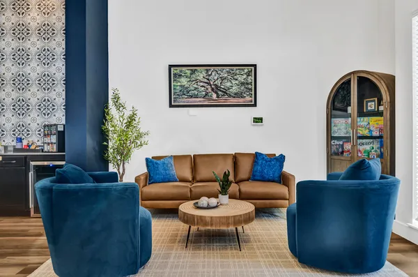 a living room with furniture a flat screen tv and a fireplace