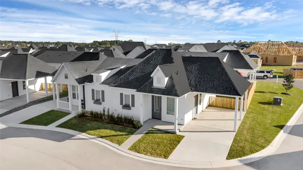 a roof deck with couch and chairs