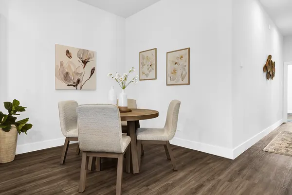 a view of a dining room with furniture and wooden floor