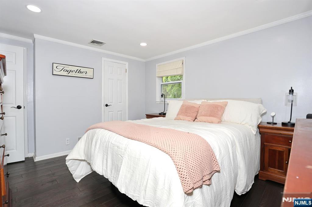 30 Brookfield Road Dumont, NJ 07628 - Photo 15 of 50 a bedroom with a bed and wooden floor