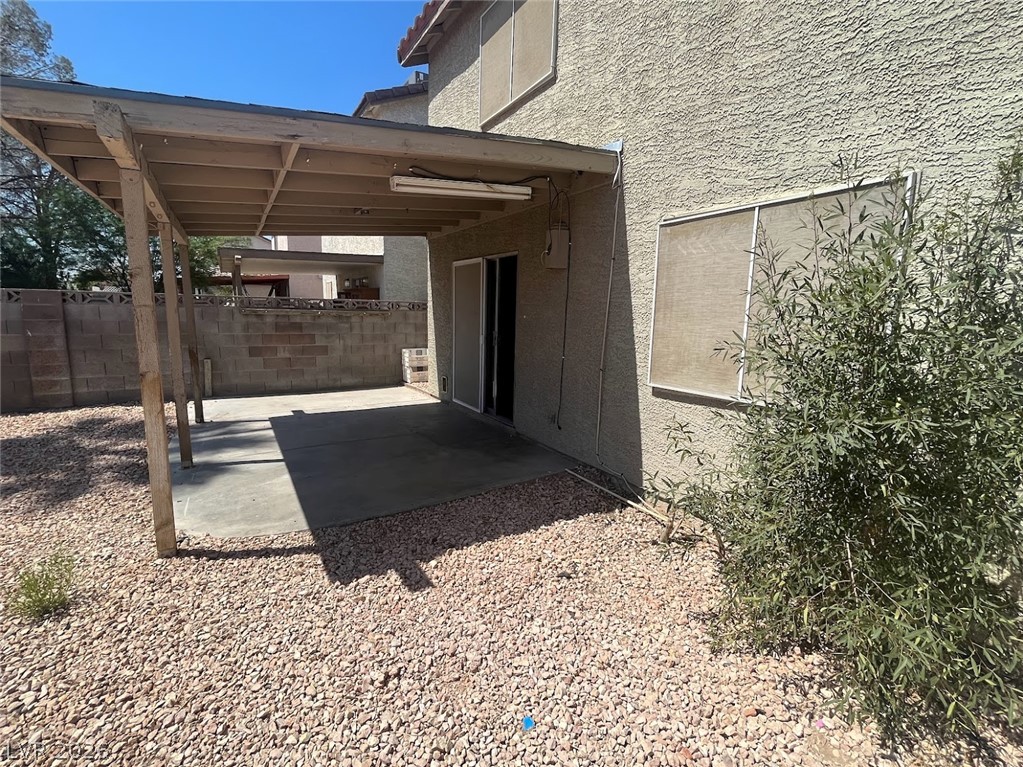 914 Scarlet Ridge Drive Las Vegas, NV 89128 - Photo 14 of 25 A private backyard retreat featuring a covered patio and xeriscape landscaping.