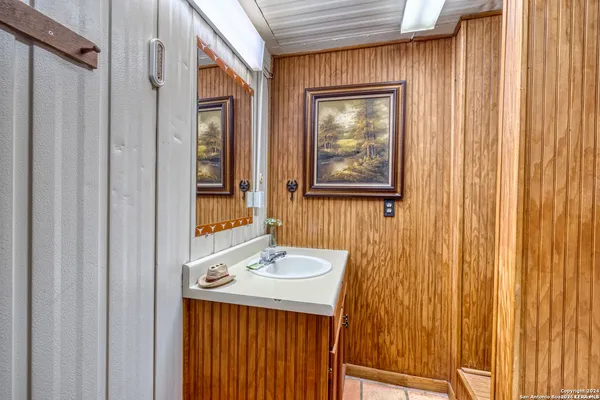 a bathroom with a sink a mirror and a shower curtain