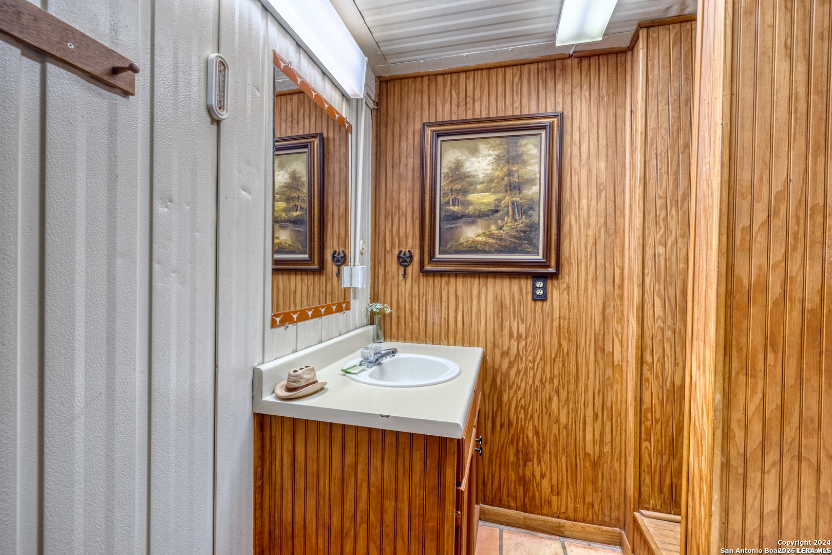 711 Mariposa Concan, TX 78838 - Photo 12 of 23 a bathroom with a sink a mirror and a shower curtain