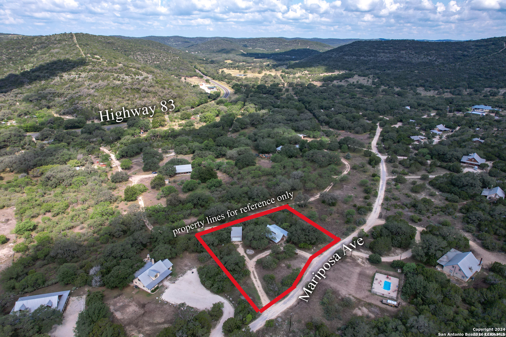 711 Mariposa Concan, TX 78838 - Photo 17 of 23 an aerial view of residential houses with outdoor space and mountain view