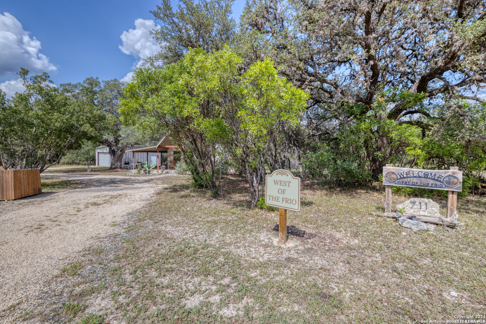 711 Mariposa Concan, TX 78838 - Photo 2 of 23 a view of a park with plants and a bench