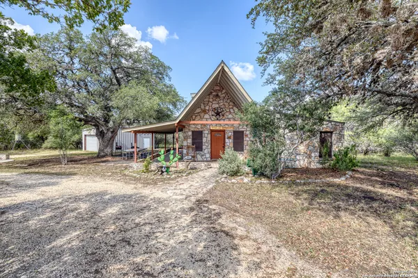 a view of house with backyard and seating area