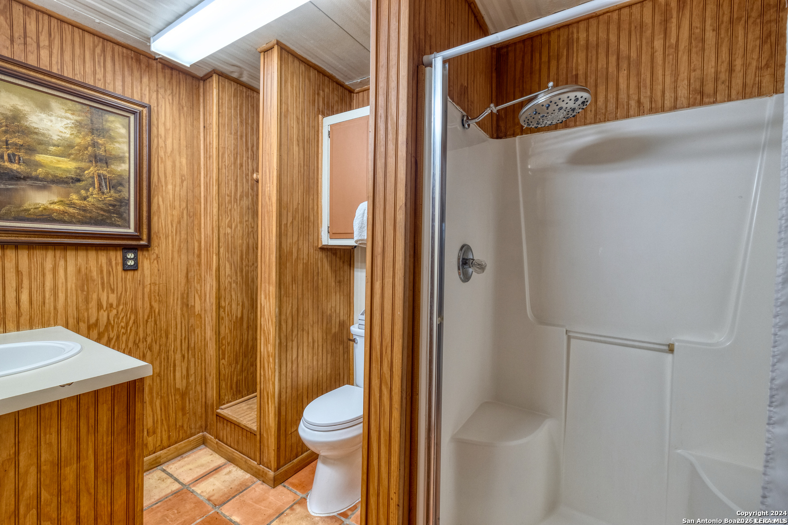 711 Mariposa Concan, TX 78838 - Photo 9 of 23 a bathroom with a granite countertop sink mirror vanity and toilet
