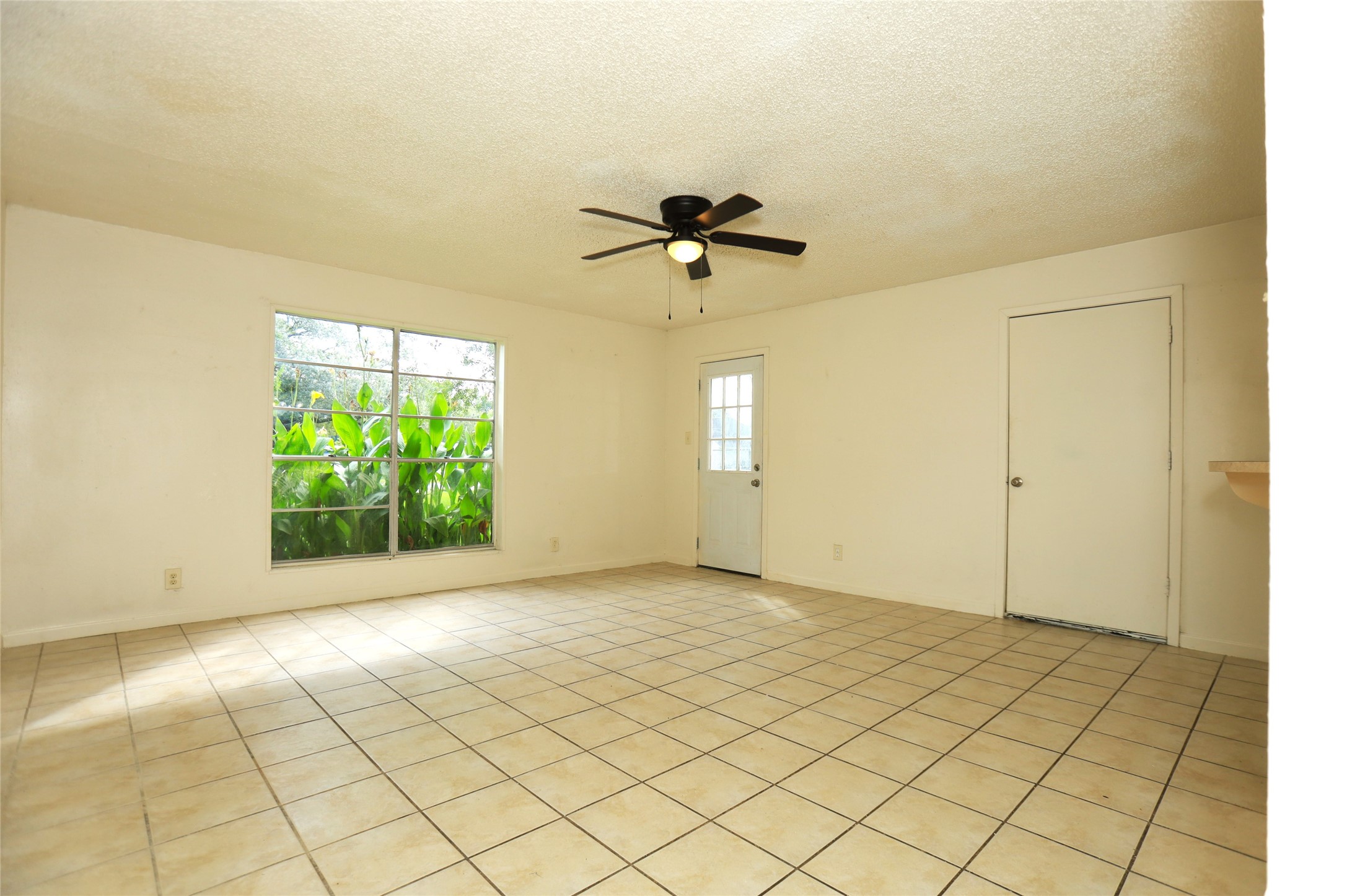 1131 Gifford Road Angleton, TX 77515 - Photo 2 of 14 an empty room with windows and fan