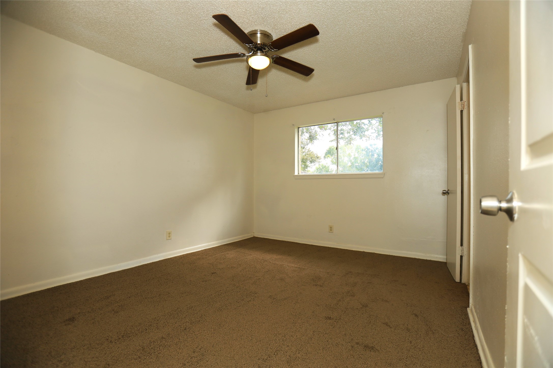 1131 Gifford Road Angleton, TX 77515 - Photo 5 of 14 an empty room with windows and ceiling fan