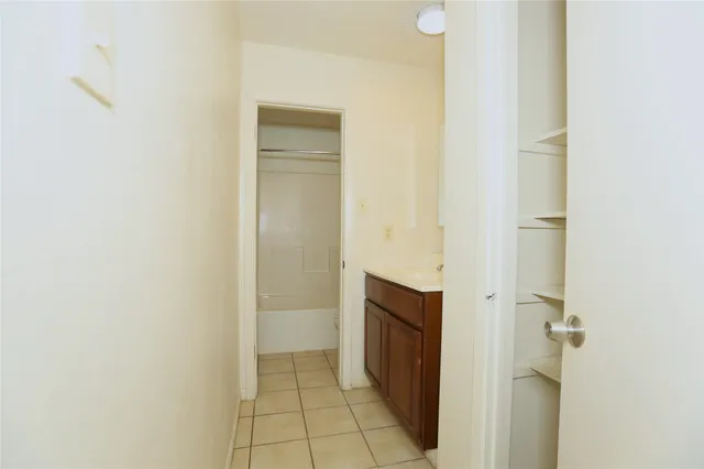 a view of bathroom with a shower and a sink