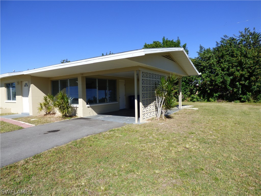 307 East Penn Road Lehigh Acres, FL 33936 - Photo 2 of 20 a front view of a house with porch