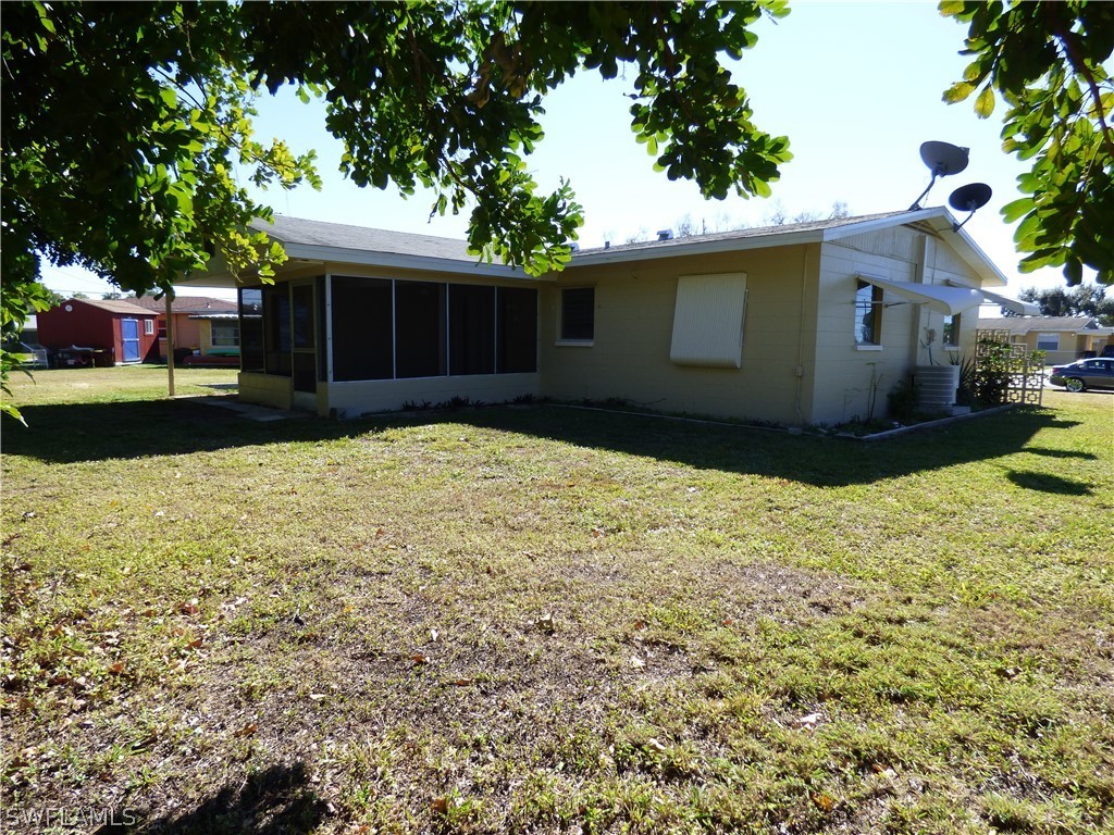 307 East Penn Road Lehigh Acres, FL 33936 - Photo 6 of 20 a house view with a garden space