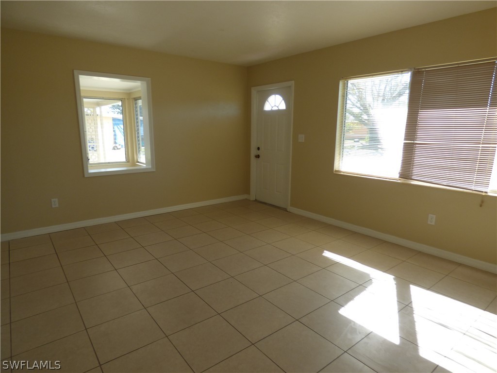307 East Penn Road Lehigh Acres, FL 33936 - Photo 9 of 20 a view of an empty room and window
