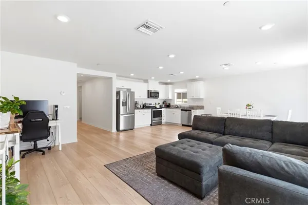 a living room with furniture and kitchen view