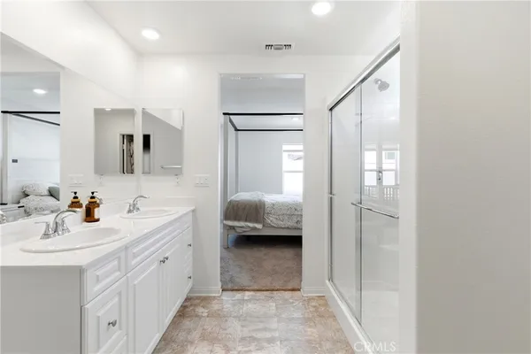 a en suite bathroom with a double sink shower and mirror