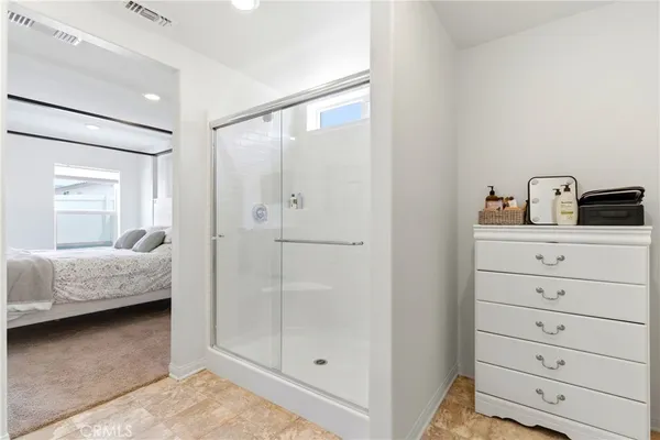 a bedroom with a bed and a mirror