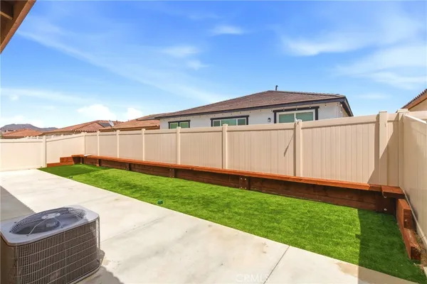 a view of a backyard with wooden fence