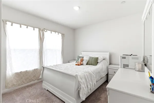 a bedroom with a bed and a large window