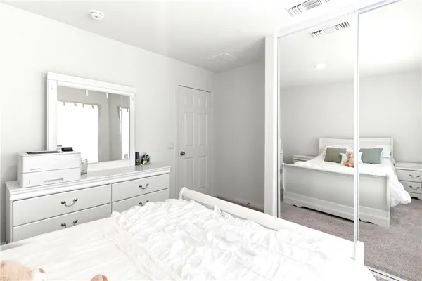 a room with a bed and a dresser